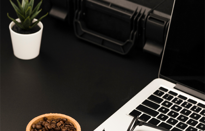 laptop and coffee beans on desk
